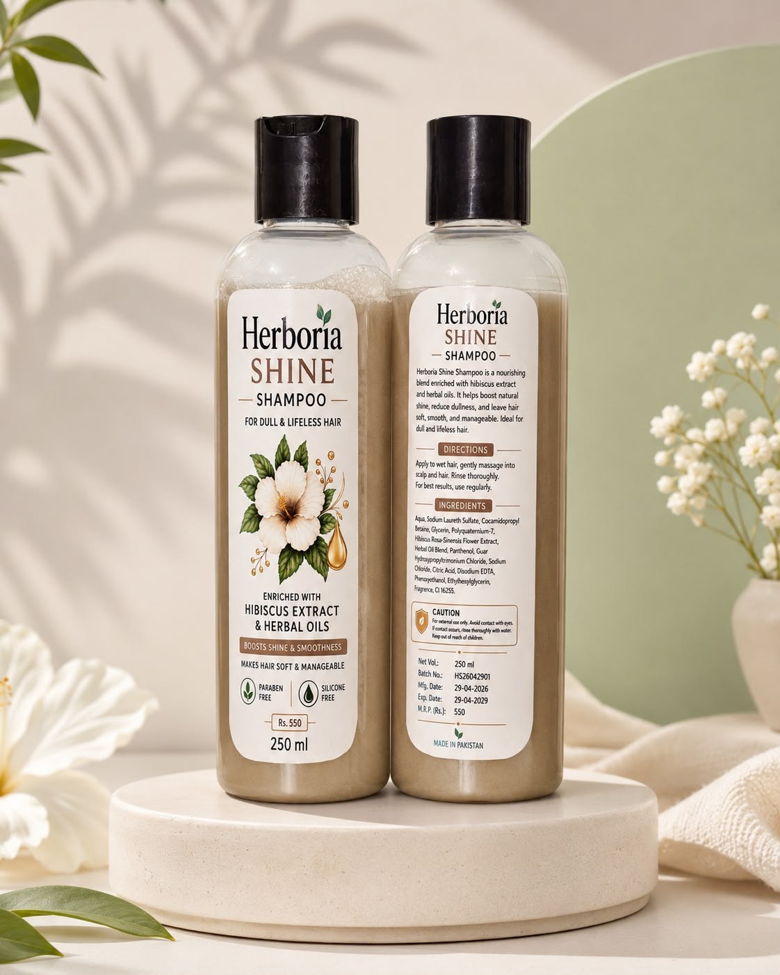 Herboria Shine shampoo front and back bottles in studio setting